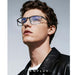 Blessing's blue light blocking glasses with black metal frames and clear lenses, worn by a male model.