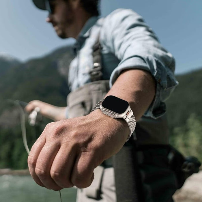 Blessing magnetic mesh loop band for Apple Watch, silver stainless steel Milanese strap on a man's wrist while fishing.