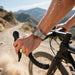 Blessing Magnetic Mesh Loop Band for Apple Watch, silver stainless steel Milanese strap on a man's wrist while cycling.