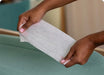 Blessing Sells 3 pack Pampers Complete Clean 72 wipes, white non-woven fabric, being held by hands.