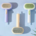 Blessing Sells purple, white, and beige double-sided pet grooming combs with self-cleaning buttons.