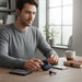 Blessing Sells Philips SportPro True Wireless Earbuds in navy blue, with charging case and one earbud on a wooden desk.