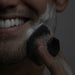 Blessing Sells dark grey silicone face scrubber with textured grip, used for exfoliation and cleansing.