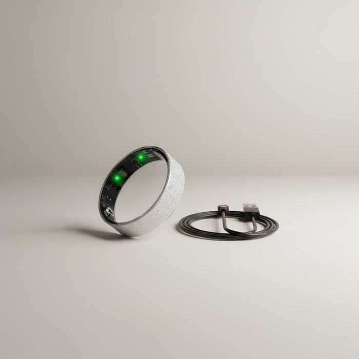 Blessing Sells smart ring with diamond inlay, fitness tracker, and USB charging cable. Silver textured band with green LED lights.
