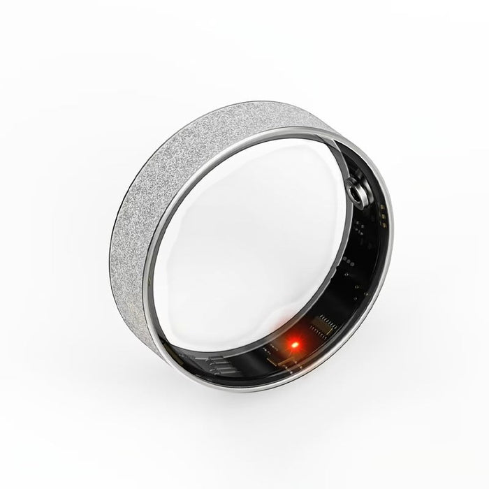 Blessing Sells smart ring with diamond inlay, silver textured band, internal circuitry visible with a red LED light.